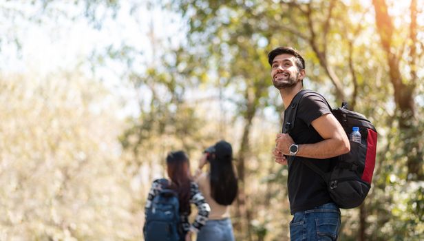 Group of young friends traveler in nature. Happy Bearded Man backpacker on vacation. Copy space.