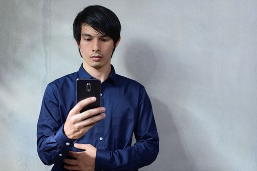 Asian businessmen are using smartphones.