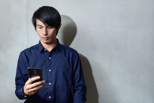 Asian businessmen are using smartphones.