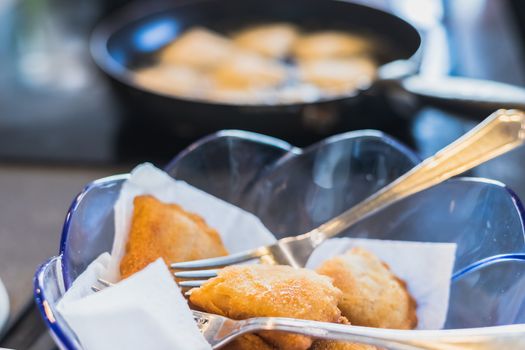 fried portuguese or brazilian rissoles in a pan in a kitchen