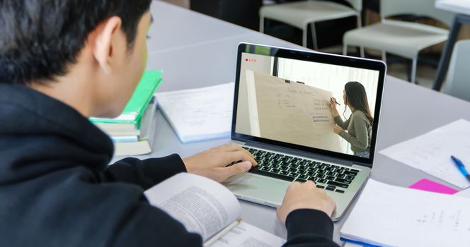 Asian students use notebook and tablet computers to work and study online at home during the coronavirus epidemic and quarantine at home
