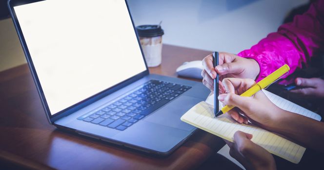 Two Asian business women use notebooks and tablet computers in meetings and work-related discussions. And she both quarantine and work at home during the corona virus epidemic.