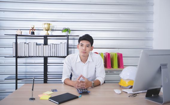 Asian man blogger broadcasting a video for selling product online such as Hats, shoes, headphones, clothing, safety headers.Shopping online concept  at home