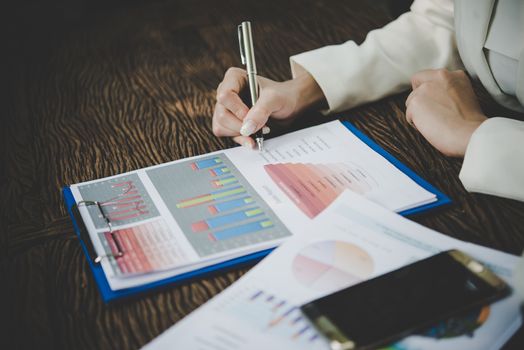 Business woman working with analysis marketing document .