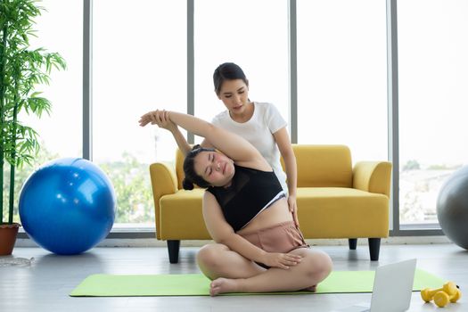 Asian woman yoga exercising at home  