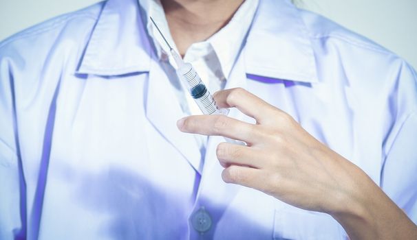 Doctor holding medical injection syringe  and Medicine plastic vaccination equipment with needle .Nurse or doctor. Liquid drug or narcotic for treatment coronavirus%2Fcovid-19, Health care in hospital.