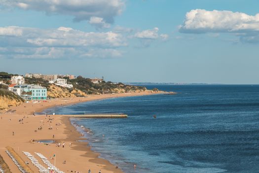 Albufeira, Portugal - May 3, 2018: High view of the city beaches in a very tourist destination in southern Portugal, in the Algarve where people are resting on a spring day