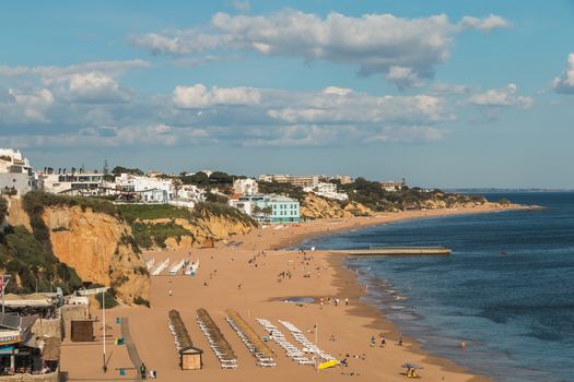 Albufeira, Portugal - May 3, 2018: High view of the city beaches in a very tourist destination in southern Portugal, in the Algarve where people are resting on a spring day