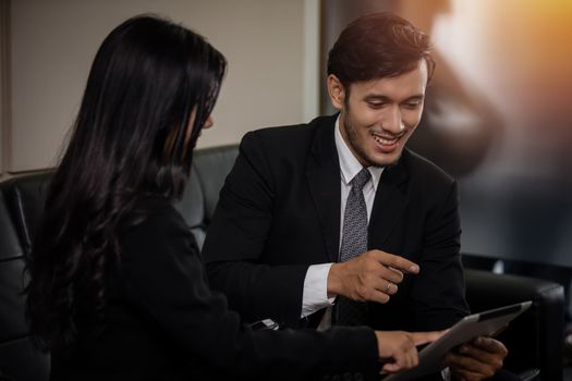 businessmen and group using notebook for business partners discussing documents and ideas at meeting and business women smiling happy for working