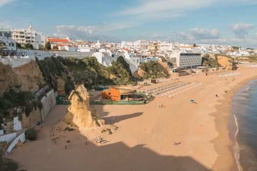 Albufeira, Portugal - May 3, 2018: High view of the city beaches in a very tourist destination in southern Portugal, in the Algarve where people are resting on a spring day