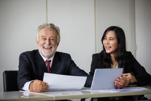 businessmen holding documents for business partners discussing  and share ideas at meeting and business women smiling happy for working
