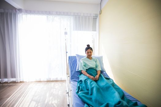 Woman patient sitting on a doctor lying in bed at Hospitals