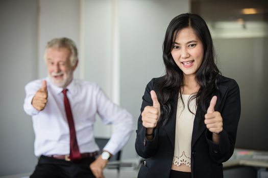 Asian business women and group using notebook for meeting and business women smiling happy for working