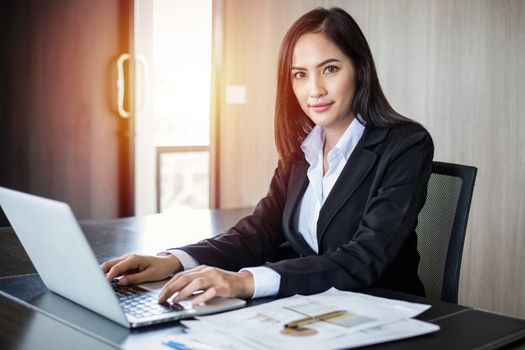 Asian business women using notebook and smiling happy for working