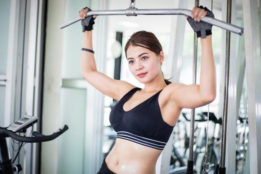 beautiful muscular fit woman exercising building muscles and fitness woman doing exercises in the gym. Fitness - concept of healthy lifestyle