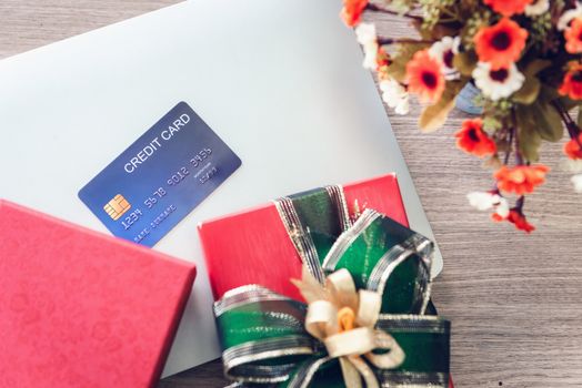 Shopping Online and Holiday Celebration Concept, Present Gift Box and Credit Card on Laptop. Celebrate Anniversary Greeting Presents Event