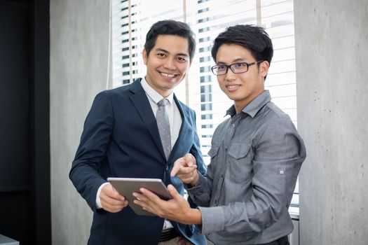 Asian businessmen and group using notebook for business partners discussing documents and ideas at meeting and business women smiling happy for working