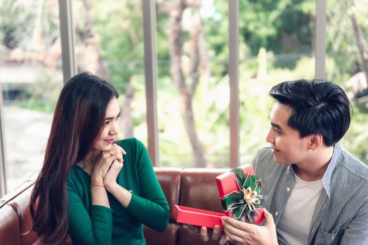 Romantic Surprise and Couple Love Valentine Concept, Young Man is Presenting Surprised to His Girlfriend at Home. Beautiful Woman Having Happiness and Surprise While Her Boyfriend Giving Presents Box.