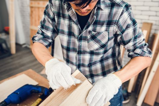 Carpenter Man is Working Timber Woodworking in Carpentry Shop, Craftsman is Screw Coring Timber Frame for Wooden Furniture in Workshop. Workmanship and Job Occupation Concept