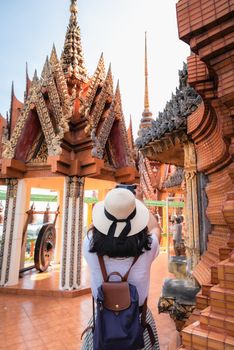 Tourist Woman Having Fun While Sightseeing in The Temple, Asian Woman Relaxing and Enjoyment While Photographing Statue of Buddha With Art Ancient Architecture in Religion Worship. Travel Exploring