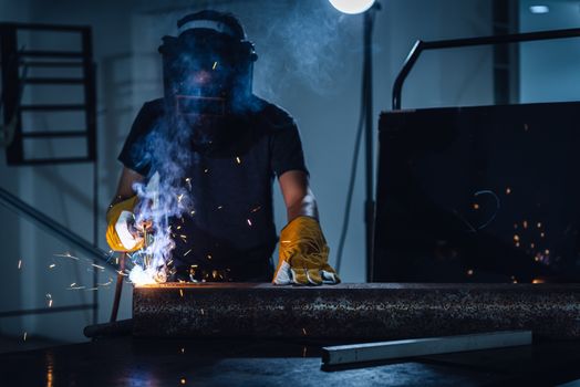 Welder Man is Welding Pipeline Fabrication Assembly in Workshop. Technician Welding in Safety Protective Equipment is Working Metalwork. Jobs Occupation/ Career Concept