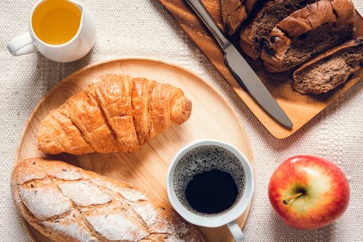 Traditional Breakfast Natural Vegetarian Food With Sourdough Bread, Coffee, Honey, Croissant on The Table., Homemade Freshly Baked French Sourdough Loaf for Breakfast. Food and Beverage Concept