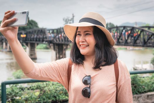 Tourist Woman Having Fun While Sightseeing in Travel Place, Asian Woman Relaxing and Enjoyment While Photographing Landmark of Ancient Architecture in Thailand. Travel Exploring and Journey Concept