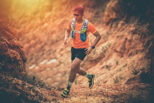 A man Runner of Trail and athlete's feet wearing sports shoes for trail running in the mountain