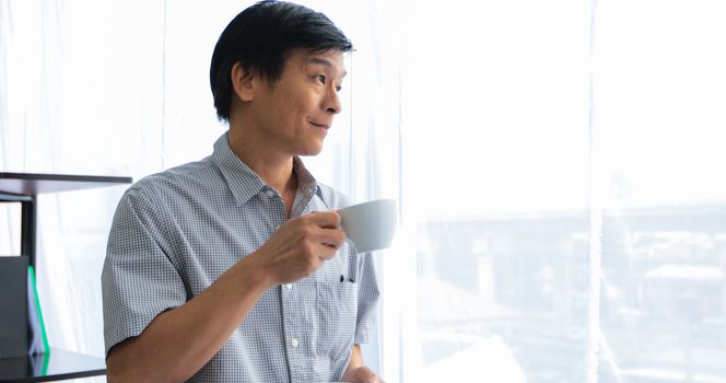 Senior Asian man drinking coffee on relaxing time