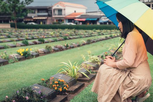 Close-Up of Religious Christian Woman Hands Clasped While Honoring and Praying to Military in War Cemetery. Teenager Woman in Expression Sadness and Pray for Soldier Prisoner of War in Tomb.