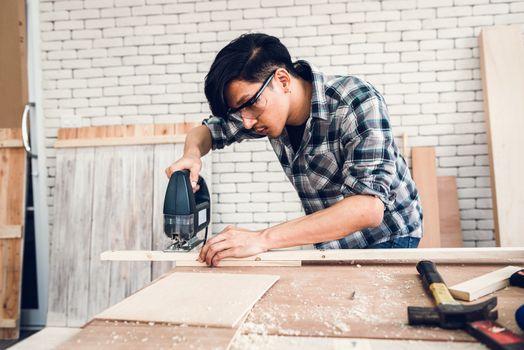 Carpenter Man is Working Timber Woodworking in Carpentry Workshops, Craftsman is Measuring Timber Frame for Wooden Furniture in Workshop. Workmanship and Job Occupation Concept