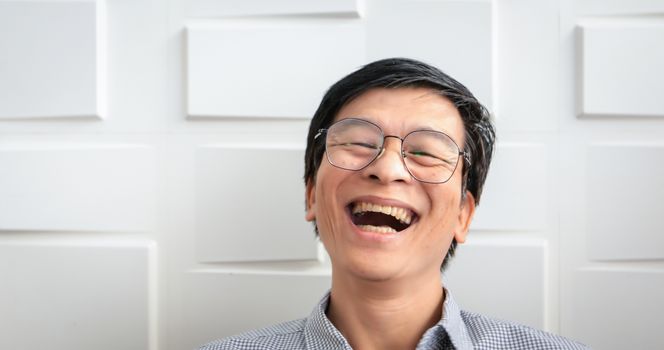 The senior Asian man smiled and laughed happy