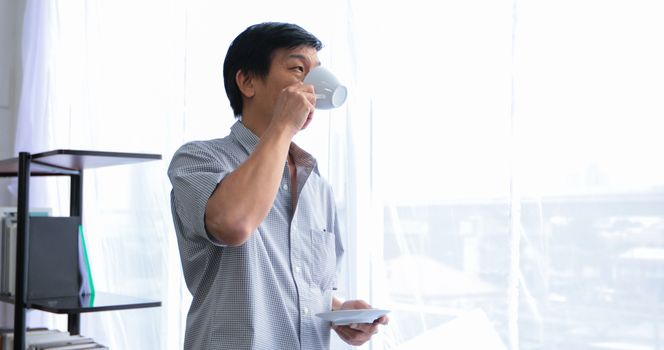 Senior Asian man drinking coffee on relaxing time