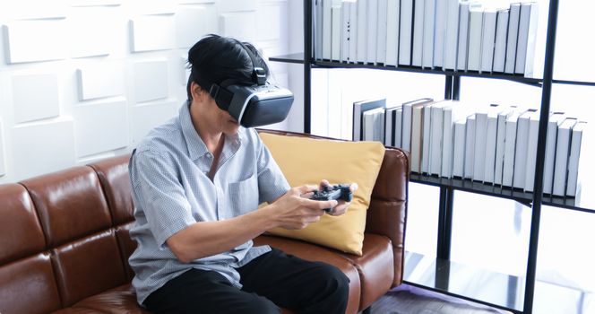 Senior Asian man using tablet and virtual reality simulator playing games in living room and feeling happy . Lifestyle Senior family at home concept.
