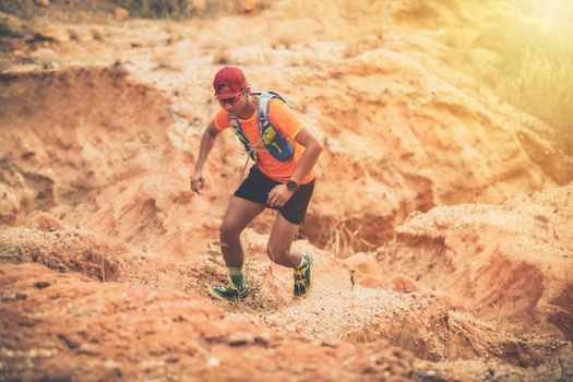 A man Runner of Trail and athlete's feet wearing sports shoes for trail running in the mountain