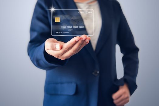 Futuristic Credit Card Banking and Business Financial Concept, Business Woman Holding Electronic Hologram Credit Card for Customer.Technology Security Electronic Payment for Future Bank, IOT Pay Tech