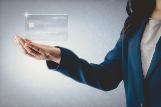 Futuristic Credit Card Banking and Business Financial Concept, Business Woman Holding Electronic Virtual Credit Card for Customer.Technology Multimedia Security Electronic Payment for Future Bank