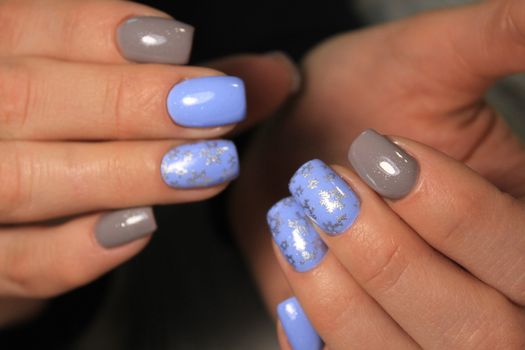 Closeup photo of a beautiful female hands with elegant manicure and diamond rings.