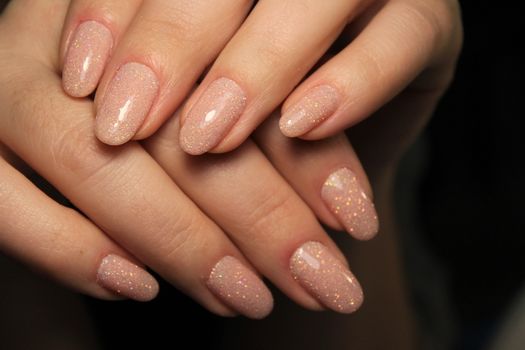 Closeup photo of a beautiful female hands with elegant manicure and diamond rings.