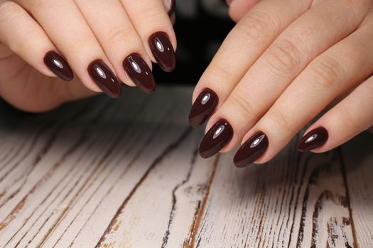 Closeup photo of a beautiful female hands with elegant manicure and diamond rings.