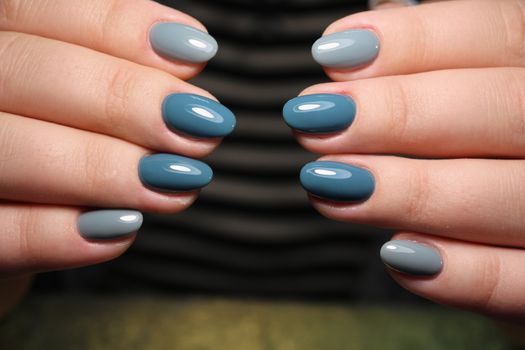 Closeup photo of a beautiful female hands with elegant manicure and diamond rings.