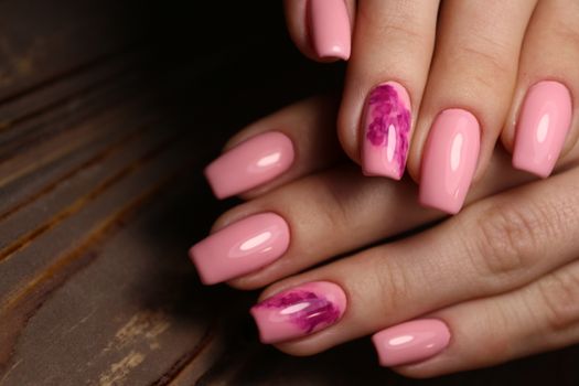 Closeup photo of a beautiful female hands with elegant manicure and diamond rings.