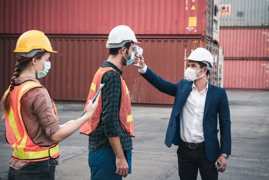 Coronavirus Covid-19 Disease Epidemic Crisis Situation, Container Shipping Worker Having Fever Body Scan by Thermometer Scanning at Ship Yard. Corona-Virus Covid19 Prevention of New Normal Concept