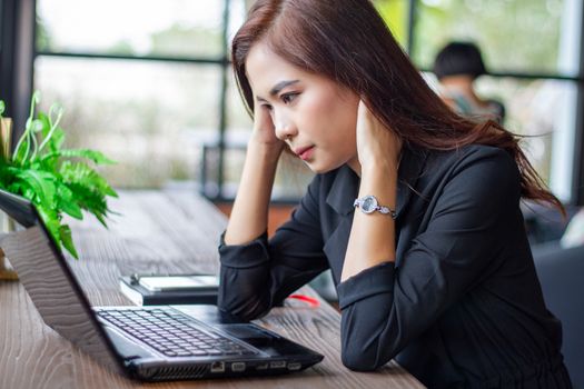 Asian businesswoman serious about the work done until the headache
