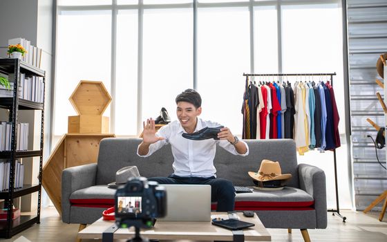 Asian man  blogger broadcasting a video for selling product online .Shopping online concept