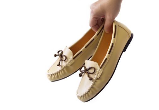 hand holding boat shoes on white background