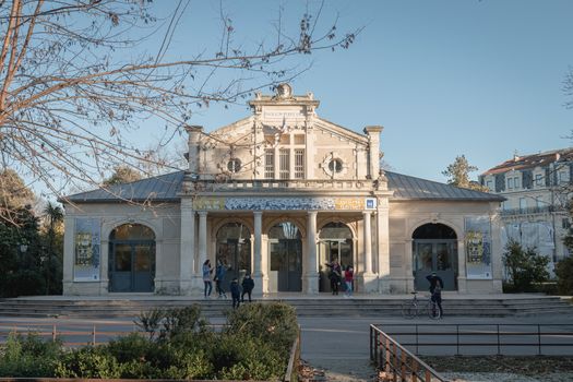 Montpellier, France - January 2, 2019: architectural detail of the popular pavilion (Pavillon Populaire) next to the Place de la Comedie where people pass on a winter day