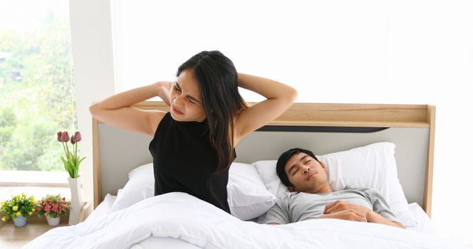 Asian couples lover waking up in her bed fully rested in morning