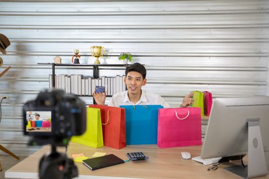 Asian man  blogger broadcasting a video for selling product online .Shopping online concept