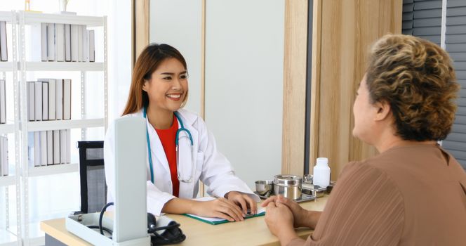 Doctor meeting and explaining medication to old woman patient at Hospitals